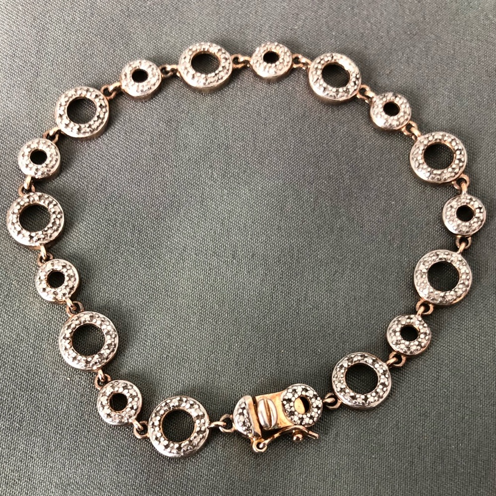Circles- gold colored charm bracelet w/ jewels.